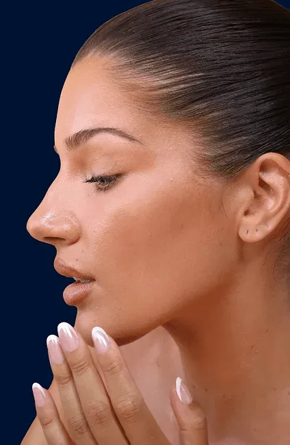 A woman in profile against a navy backdrop